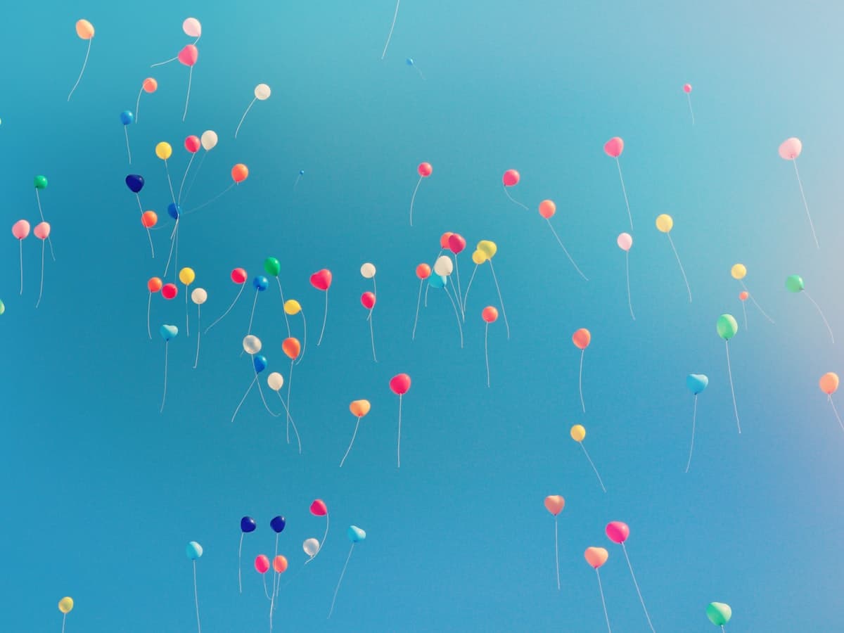 Colorful balloons floating in a blue sky
