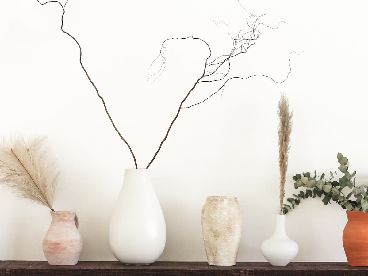 Collection of handmade vases on a wooden shelf