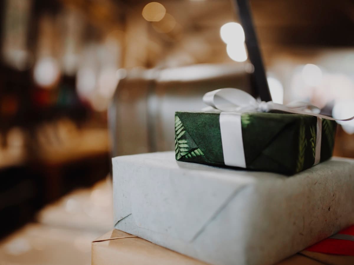 Stack of gifts wrapped in handmade paper with ribbon